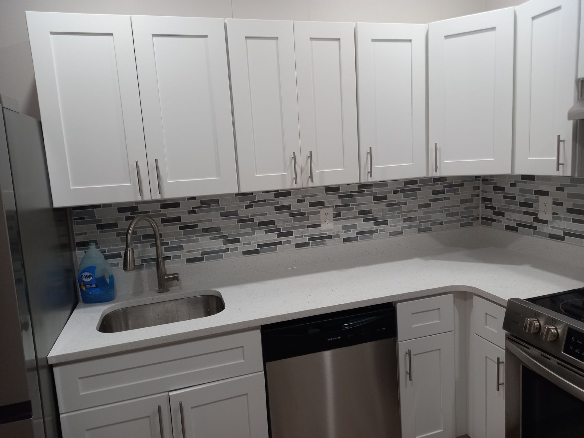 shaker soft close cabinets with quartz countertop. granite is outdated now