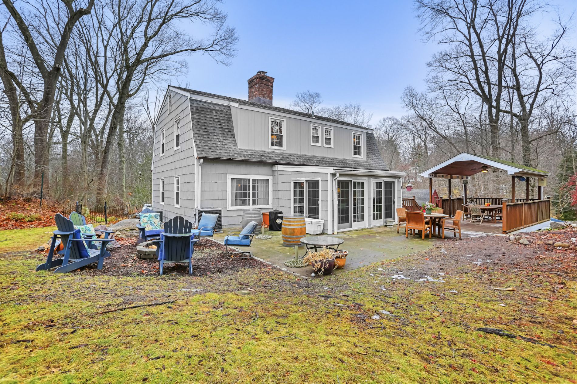 Back yard with fire pit, blue stone patio, covered deck and sun porch